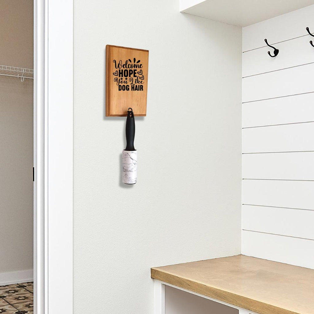 'Welcome - hope you like dog hair' lint roller holder on wall