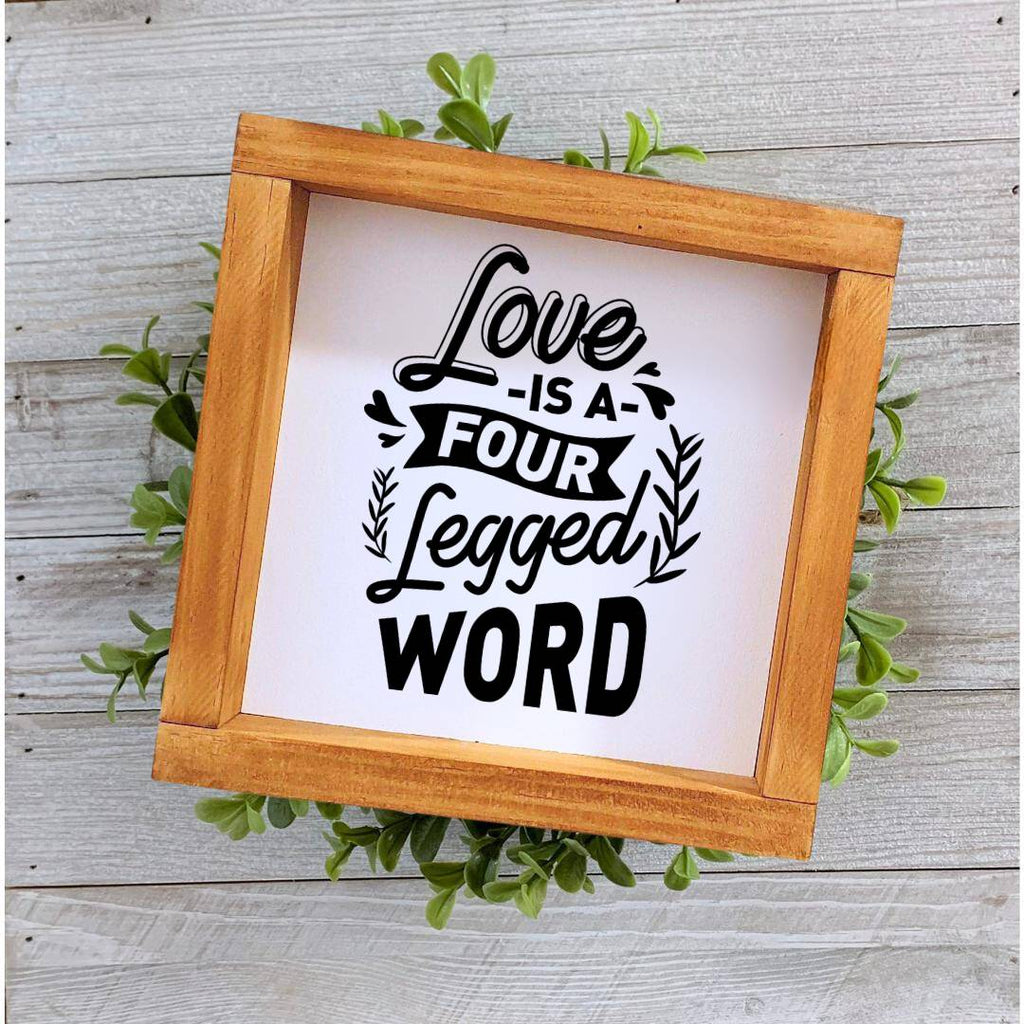 Farmhouse style wooden sign with 'Love is a four-legged word' design