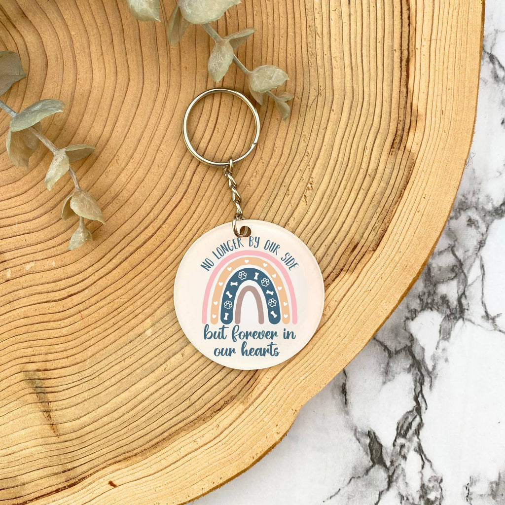 Pet remembrance keyring with rainbow and 'no longer by our side but forever in our hearts' design on wooden background