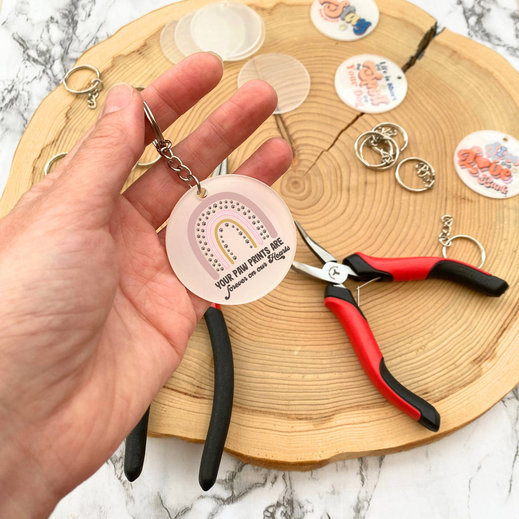 Making the handcrafted dog memorial keyring with rainbow and 'your paw prints are forever on our hearts' design