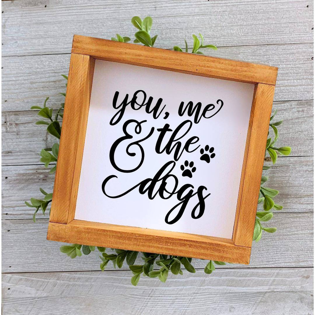Farmhouse style wooden sign with 'You, me and the dogs' design