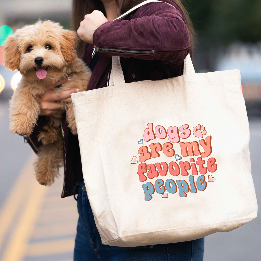 woman carrying 'dogs are my favourite people' tote bag and dog