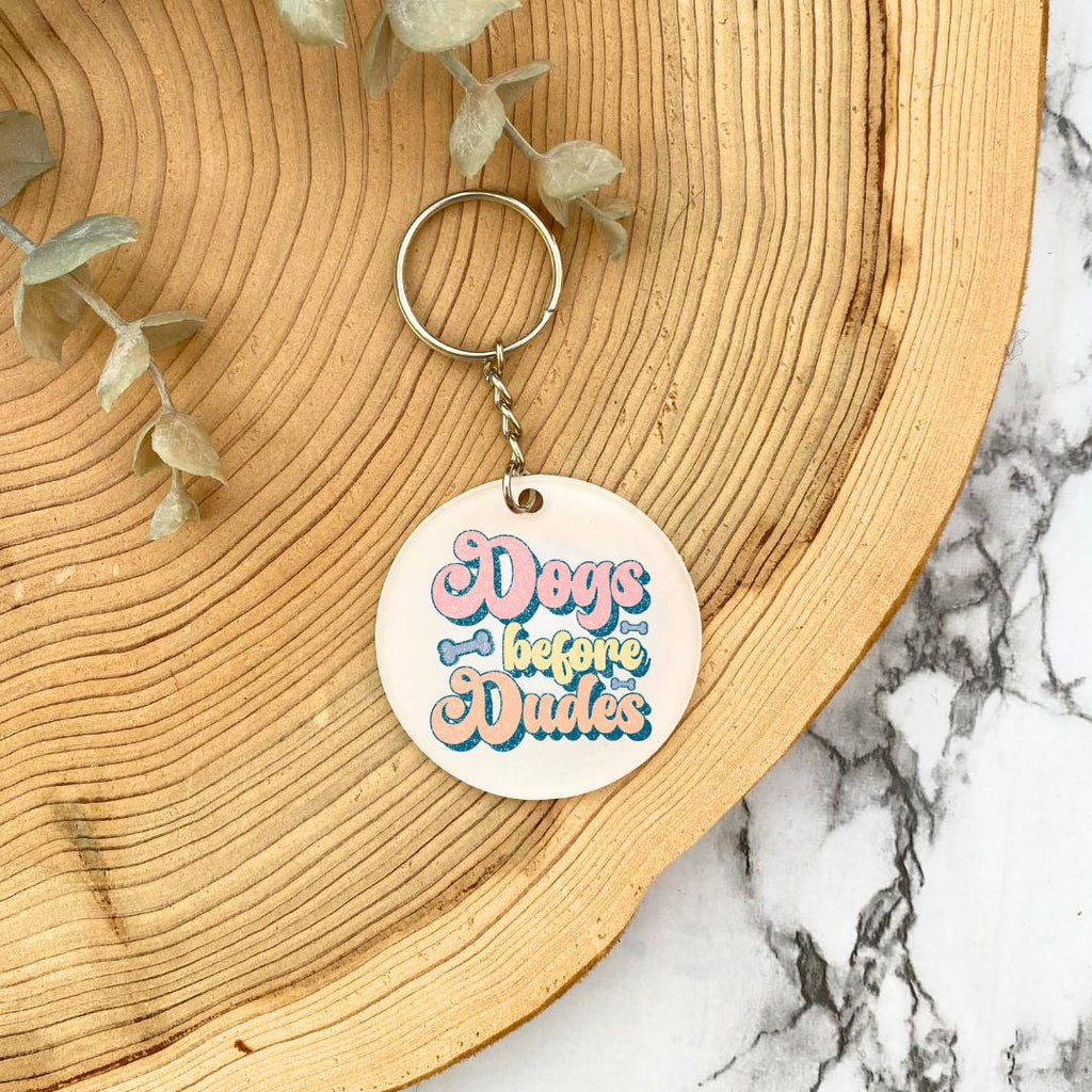 'Dogs Before Dudes' Acrylic Keyring - wooden background