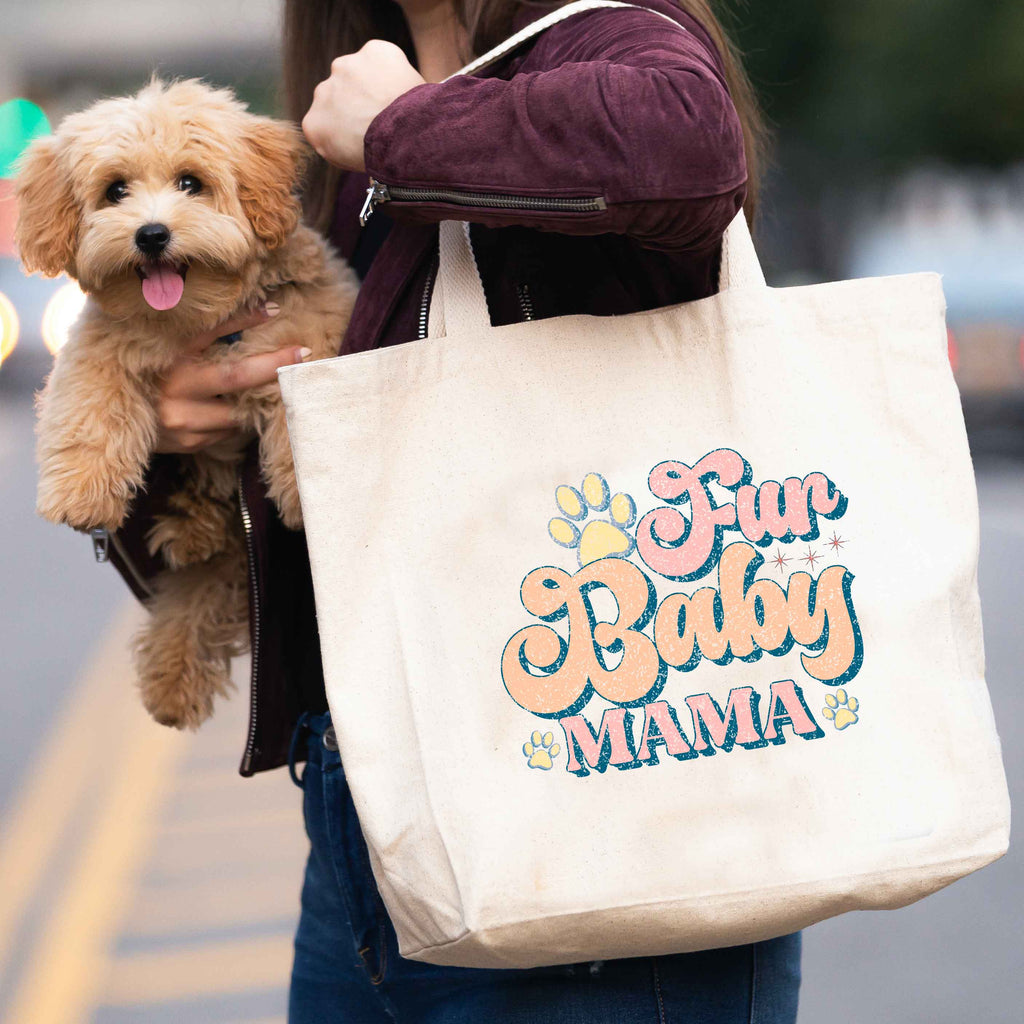 woman carrying 'fur baby mama' tote bag and dog