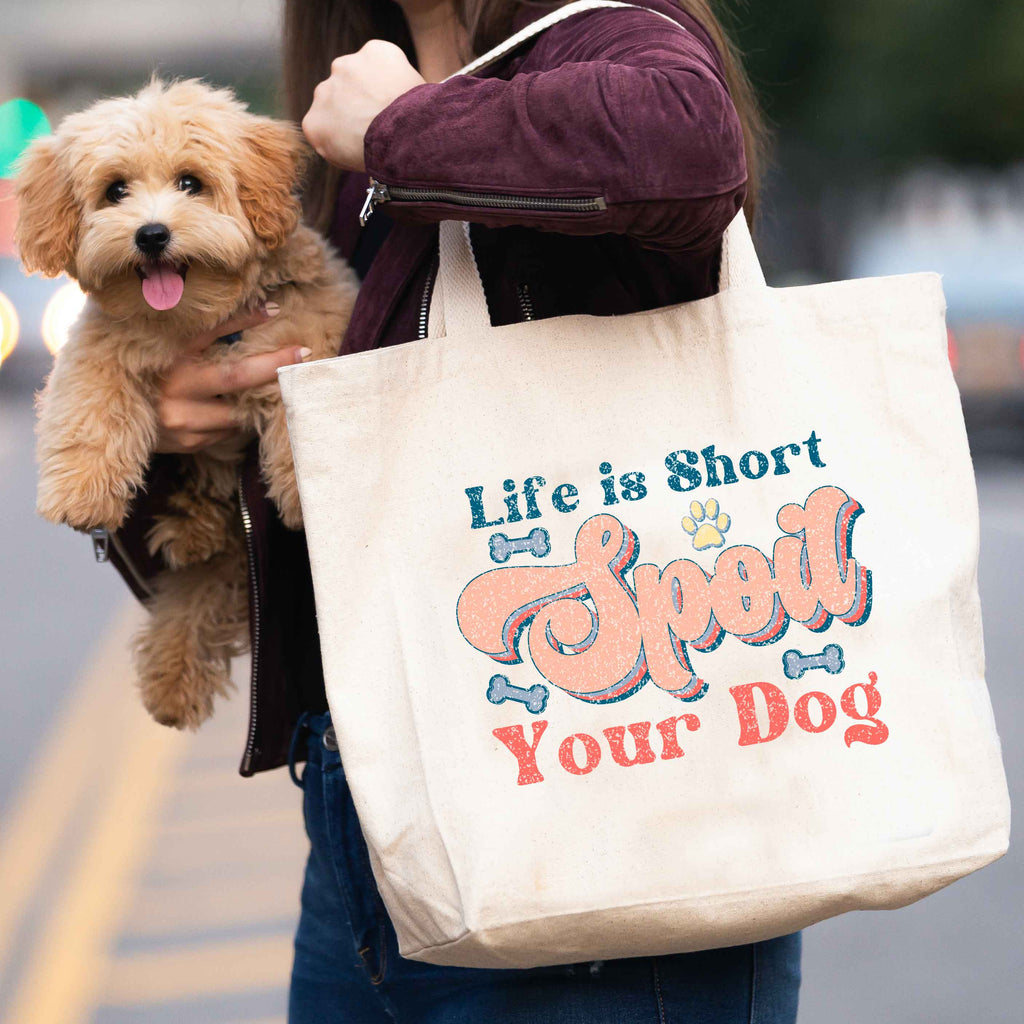 woman carrying 'life is short, spoil you dog' tote bag and dog