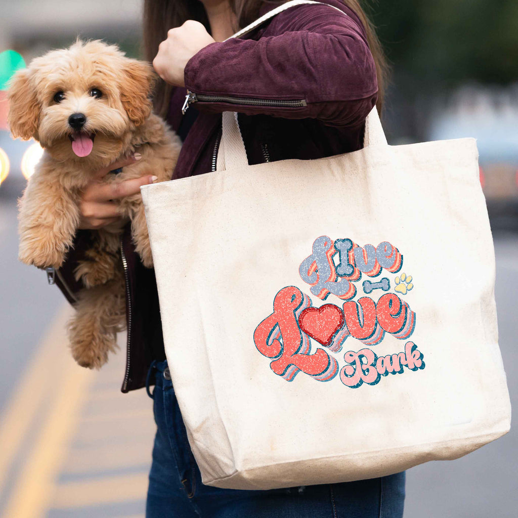 woman carrying 'Live, love, bark' tote bag and dog