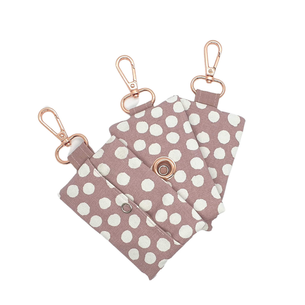 pink poo bag dispensers with rose gold clasp and grommet