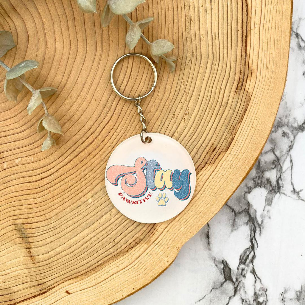 'Stay Pawsitive' Acrylic  Keyring - wooden background