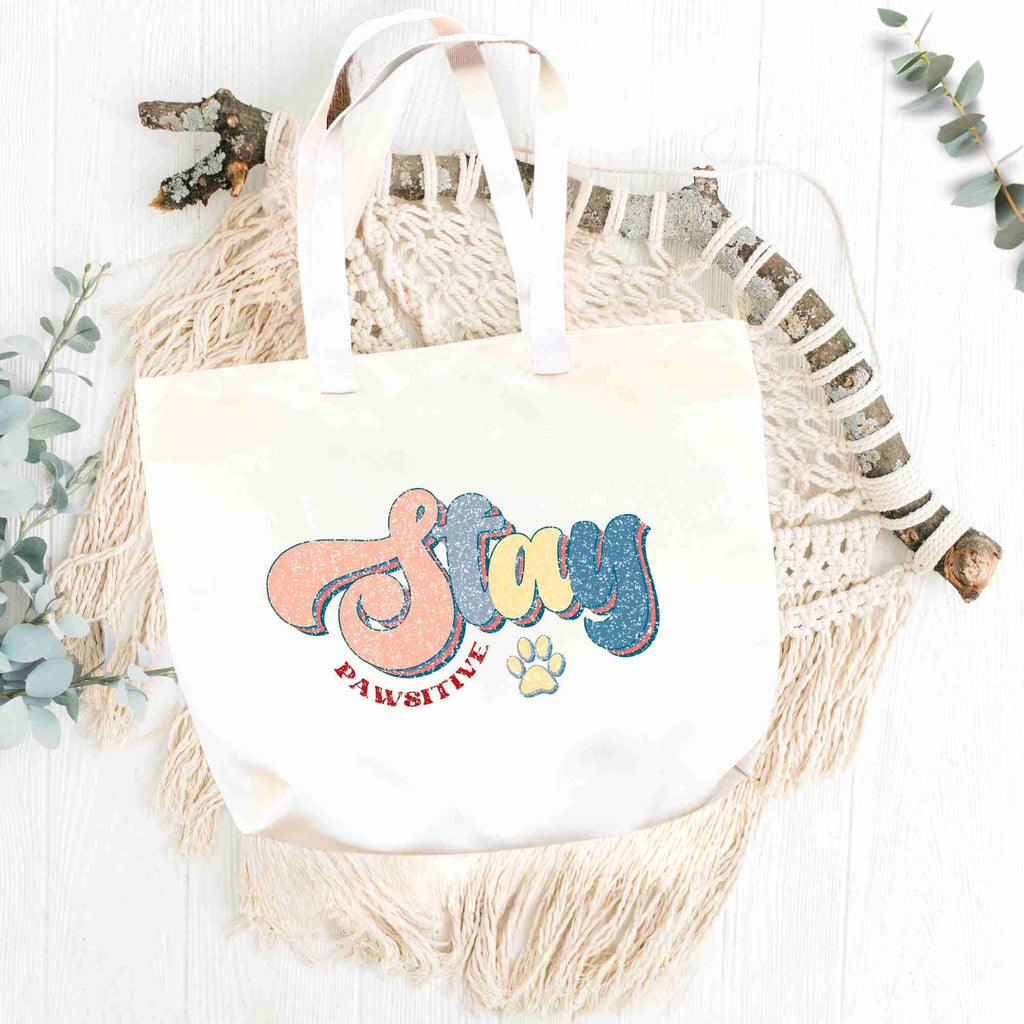 'Stay Pawsitive' tote bag flatlay