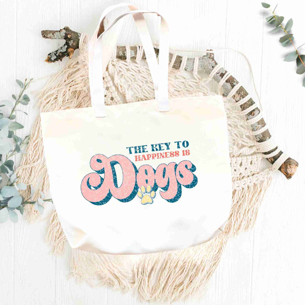 'The key to happiness is dogs' tote bag flatlay